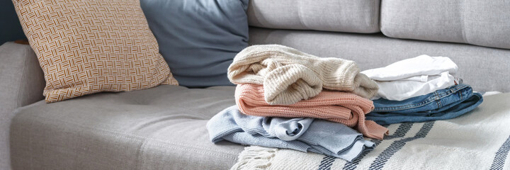 Spring cleaning,Fast fashion, the girl puts things in order in the closet. A bunch of colorful clothes. The concept of processing, second hand, eco, minimalism, consumption of goods