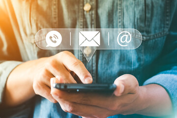 Hand of Businessman holding mobile smartphone. Contact Us, customer support concept. copy space.