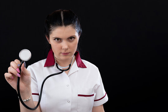 Headshot Portrait Of Nurse In Uniform With Stethoscope, Isolated On Dark Background, Copy Space