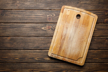 Cooking concept - cutting kitchen board on wooden background.