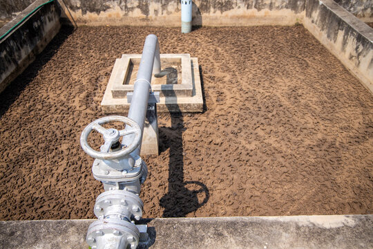 Sludge drying bed in waste-water treatment plant system, brown sand in unplanted drying bed. Waste management facility.