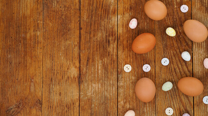 Eggs on a wooden rustic background with copy space for text.