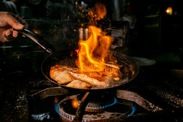 tilapia fish in preparation with fire rising