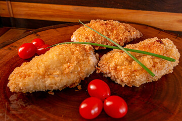cut of chicken meat stuffed with ham and cheese