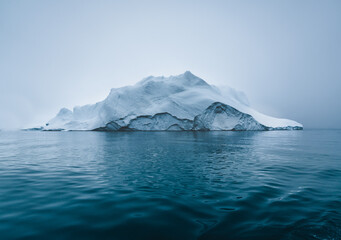 Arctic nature landscape with icebergs in Greenland icefjord with midnight sun sunset sunrise in the...