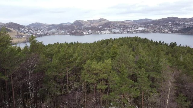 Aerial drone footage of European village next to a blue lake and mountainous background – Rogaland Norway