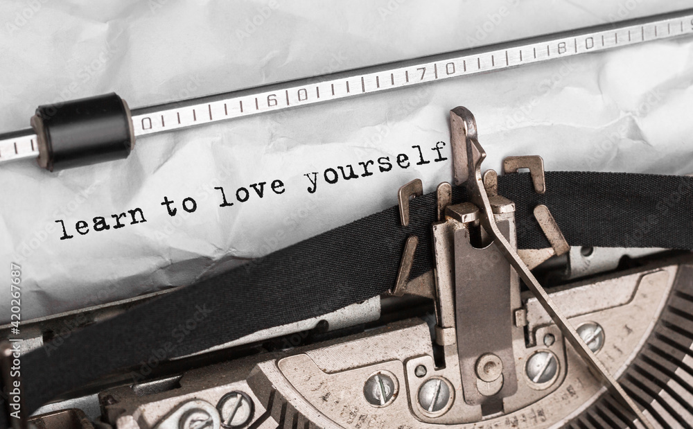 Poster text learn to love yourself typed on retro typewriter
