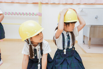 ヘルメットを被り避難する子供