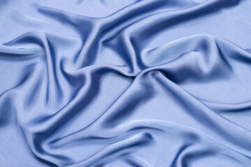 Blue silk or satin luxury fabric texture. Top view.
