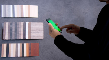 Materials Concept. Young man shopping matrials on mobile. Shopping online