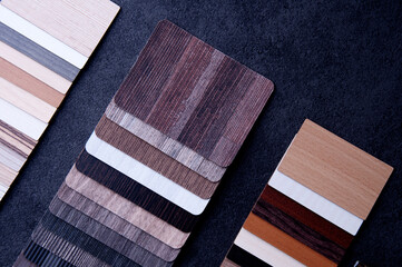  Materials Concept. Top view of wood laminate materials on wooden floor.