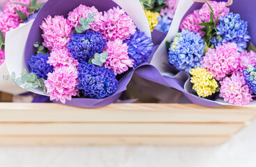 Bouquets of flowering multicolored hyacinths in a flower shop, a place for text