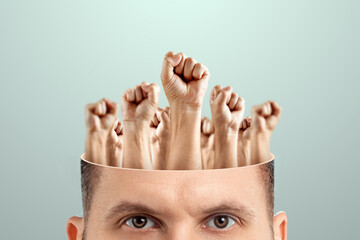 Close-up of a man's head instead of a brain, fists raised up. The concept of fighting for their...