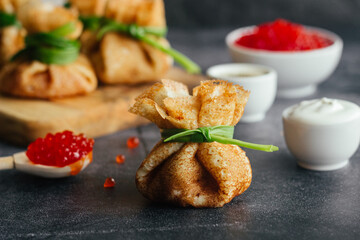 Pancakes with caviar. Pancake envelopes. Delicious pancakes on the table. 