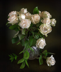 Still life with a bouquet of white withered roses. Vintage.