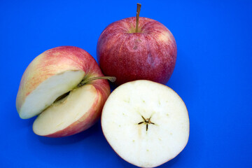 Naklejka na ściany i meble Close up of apples with a blue background