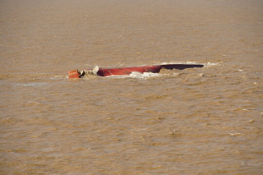Bottom of the capsized ship in the muddy river approaching to  the Shanghai, China.