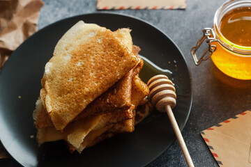 Delicious pancakes on a plate. Pancakes with honey