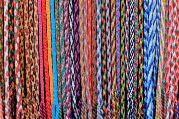 closeup of colorful stringed handmade bracelets made of colored thread