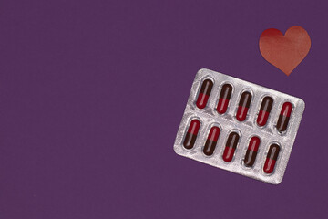 Packaging of capsules, tablets on a purple background to protect and protect the health of patients...