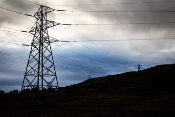 Electricity pylons in a field on a cloudy day in winter at Kendoon Power Station