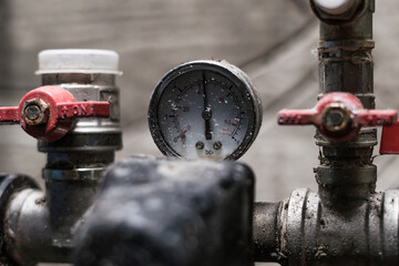 Water pressure gauge in the pumping station of a well of a private house close up