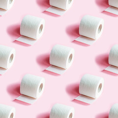 White toilet paper roll repeat seamless pattern on light pink background.