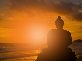 Abstract buddha silhouette on golden sunset background Beliefs and beliefs of Buddhism