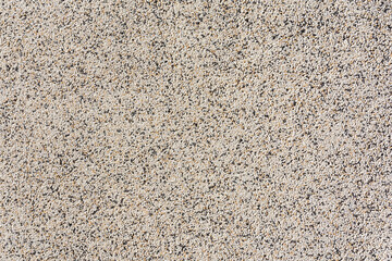 The wall of the building are lined with fine decorative plaster of beige color. As a natural background.