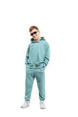 Fototapeta premium boy in a turquoise suit and white sneakers isolated on a white background.