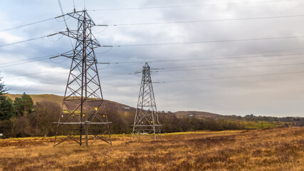 Electricity pylons in a field on a cloudy day in winter at Kendoon Power Station