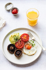 Fototapeta na wymiar Vegetarian breakfast with fried egg, tomatoes, mushroom and avocado
