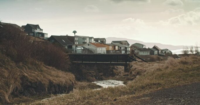 Man On A Wooden Bridge Enjoying Hail Falling Down.