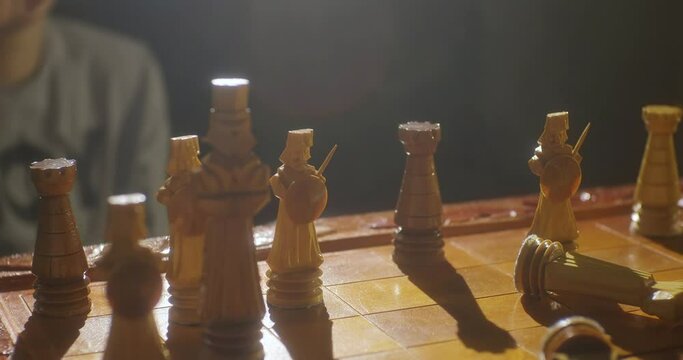The final of the chess game. The player dropping a piece of the chess king and giving up in a chess game