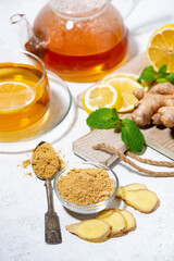 ingredients for tea for immunity - ginger, lemon and mint, vertical