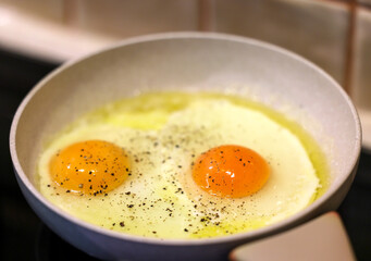 Frying pan with fried egg sprinkled with dill