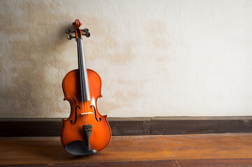 Wooden violin with old grunge wall.
