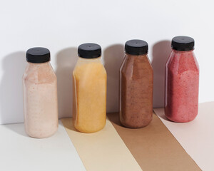 Plastic bottles with fruit and vegetable juices. The concept of the detox program, smoothies.