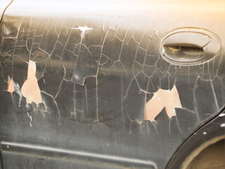 The car doors have an old paint and are on a black background.