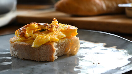 Scrambled eggs food on baquette for breakfast