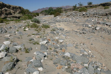 Dry Desert Riverbed Death Valley, California, with Large Stones showing a Delta Forming on Alluvial...