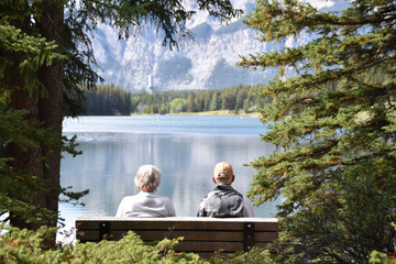 Couple Sitting on a Bench Looking at Lake