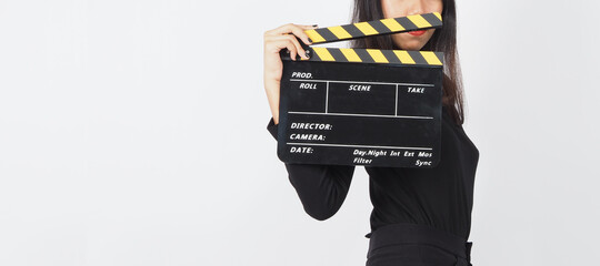 woman hand is holding black clapper board or movie slate or clapboard use in video production...