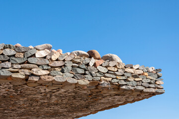 dry stone masonry bridge awning against clear blue sky