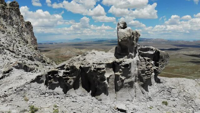 Mountain rock formation with valley vista behind.