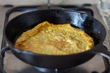 fried omelet in a frying pan at home