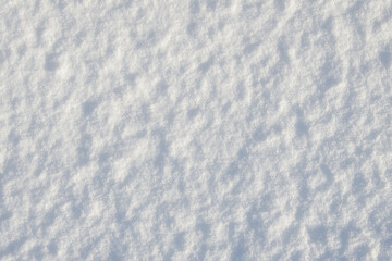 Fresh clean white snow background texture. Winter background with frozen snowflakes and snow mounds. Snow lumps. Seasonal landscape details. Cold weather.