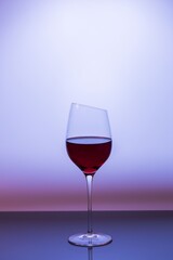 Close up view of red wine in glass isolated on purple background. 