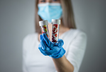 Woman holding medical instruments in blue gloves