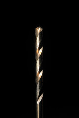 Closeup of a cobalt steel drill bit with black background